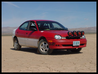 Neon rallycar on the dry lake